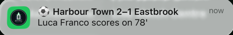 A phone notification reading: Harbour Town 2–1 Eastbrook — Luca Franco scores on 78'
